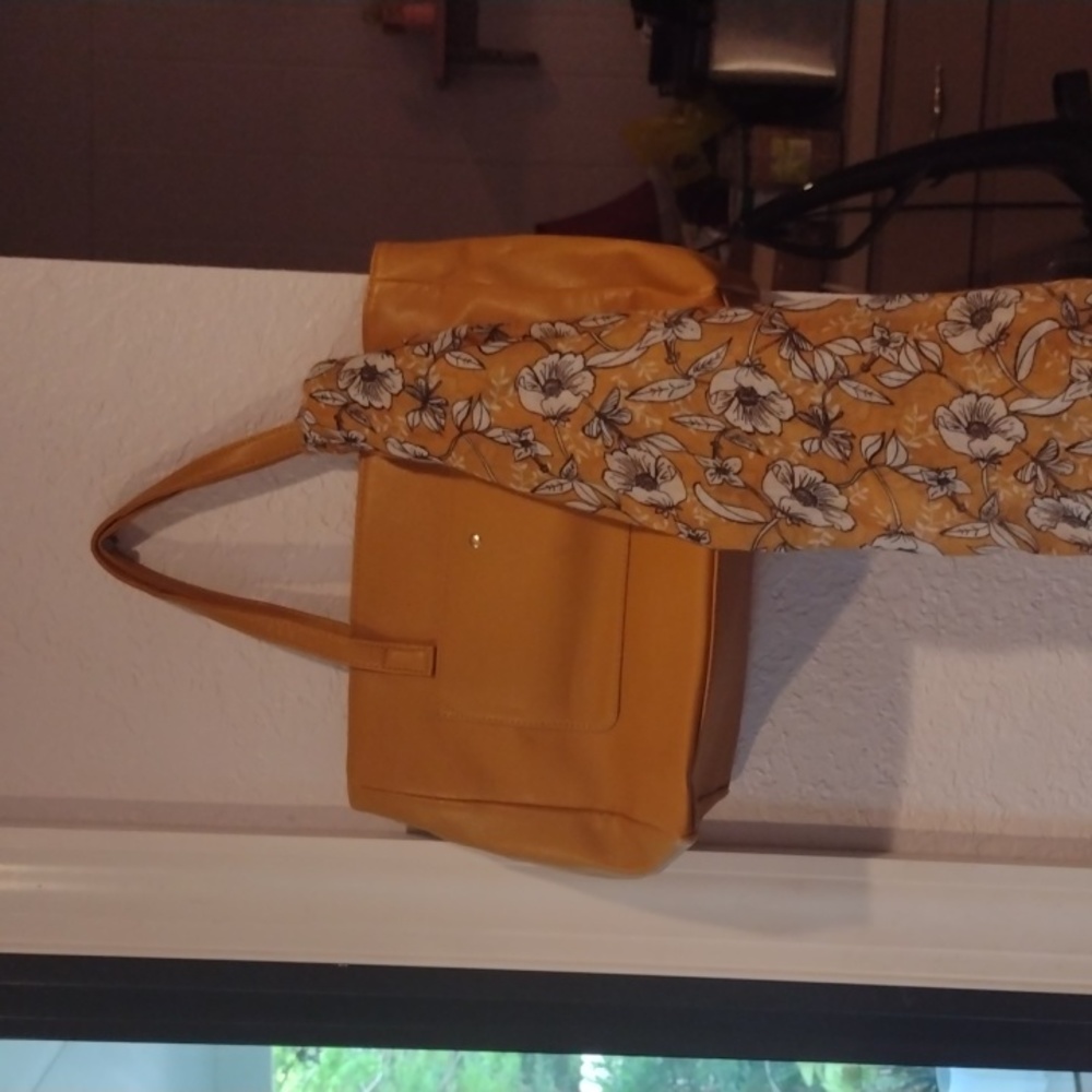 This is a new mustard colored or orange purse with matching scarf.